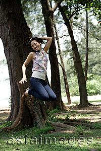 Asia Images Group - Young woman in park, jumping