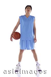 Asia Images Group - Young man standing with basketball