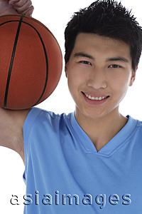 Asia Images Group - Young man with basketball, smiling