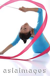 Asia Images Group - Rhythmic gymnastics, female gymnast doing routine with ribbon