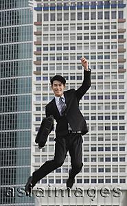 Asia Images Group - Businessman jumping in air, smiling