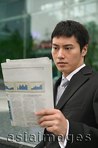 Asia Images Group - Businessman using reading newspaper