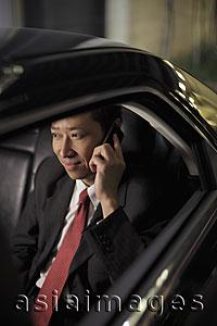 Asia Images Group - Mature man sitting in car talking on phone