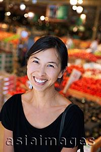 Asia Images Group - Portrait of woman smiling in market