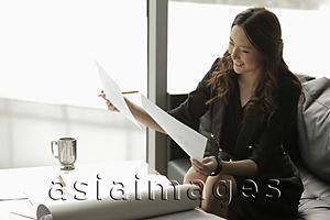 Asia Images Group - Young woman working in an office