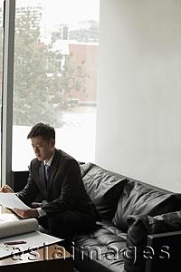 Asia Images Group - Young man working in an office