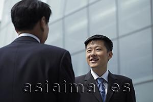 Asia Images Group - Businessmen talking together outside