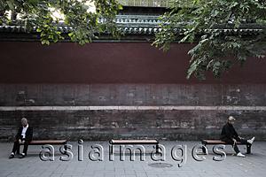 Asia Images Group - Old people sitting on benches at a park, Beijing, China