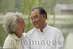 Asia Images Group - Head shot of older couple looking at each other and smiling.