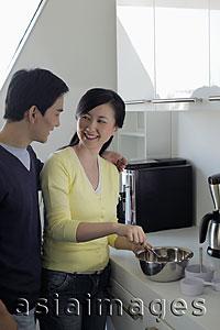 Asia Images Group - Couple making food together in the kitchen