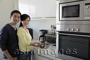 Asia Images Group - Couple standing in kitchen together
