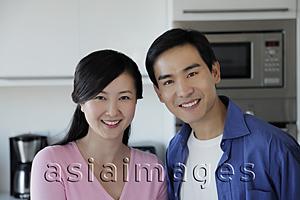 Asia Images Group - Couple smiling together in kitchen