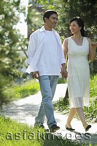 Asia Images Group - Young couple holding hands and smiling