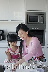 Asia Images Group - Mother teaching her daughter how to cook