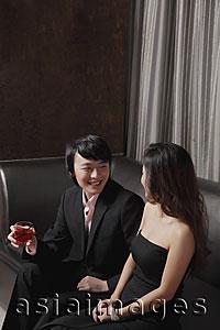 Asia Images Group - Young couple sitting together on a sofa