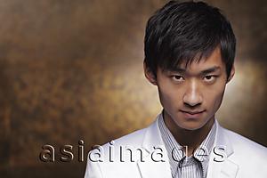 Asia Images Group - Head shot of young man in white coat