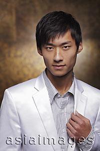 Asia Images Group - Head shot of young man in white coat