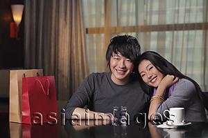 Asia Images Group - Young couple sitting in restaurant together