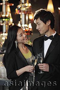Asia Images Group - A young couple dressed up toasting with champagne glasses