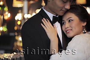 Asia Images Group - Dressed up couple hugging each other at night