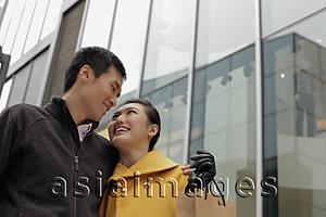 Asia Images Group - Young couple looking at each other while shopping