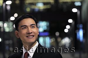 Asia Images Group - Man wearing business suit on the street at night