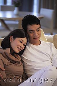 Asia Images Group - Young couple sitting on sofa together