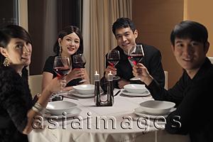 Asia Images Group - Young people drinking wine at a dinner party