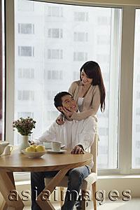 Asia Images Group - Young couple smiling at each other in their condo