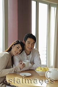Asia Images Group - Young couple sitting together in their home