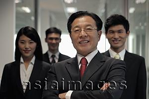 Asia Images Group - Businessman standing in front of colleagues