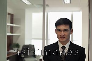 Asia Images Group - Head shot of young man in his office