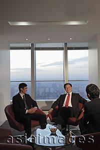 Asia Images Group - Three businessmen talking in an office