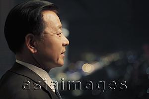 Asia Images Group - Head shot of man looking out the window at night