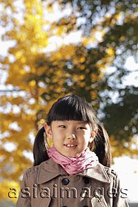 Asia Images Group - Head shot of young girl in coat outdoors