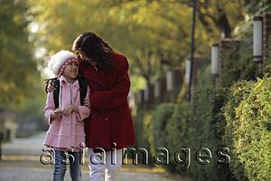 Asia Images Group - Mother and daughter walking down street together laughing