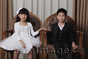 Asia Images Group - Young boy and girl dressed in nice clothes holding hands