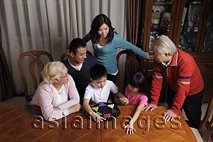 Asia Images Group - Three generation family playing Chinese checkers together
