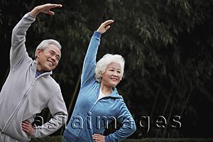 Asia Images Group - Senior man and woman stretching together