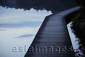 Asia Images Group - Wooden path over a lake in the evening