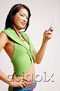 AsiaPix - Young woman with mobile phone, hand on hip, looking at camera