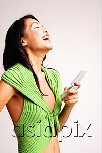 AsiaPix - Young woman holding mobile phone, laughing