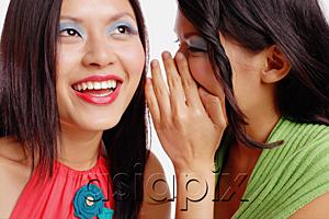 AsiaPix - Two women, one looking up, woman next to her whispering