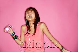 AsiaPix - Young woman with mp3 player, laughing