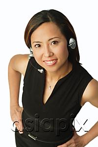 AsiaPix - Woman using headset, smiling up at camera
