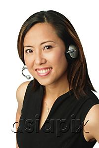 AsiaPix - Woman using headset, smiling at camera