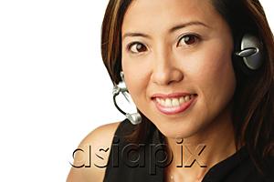 AsiaPix - Woman using headset, portrait
