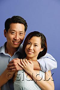 AsiaPix - Man hugging woman, both facing camera, portrait
