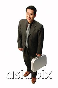 AsiaPix - Businessman with briefcase, smiling at camera