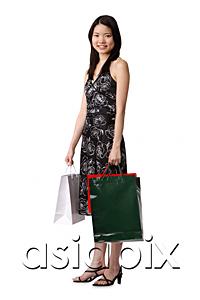 AsiaPix - Young woman carrying shopping bags, portrait